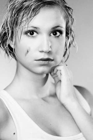 Dirty and wet hair nice blonde girl posing in studio for personal portraits.の写真素材