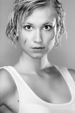 Dirty and wet hair nice blonde girl posing in studio for personal portraits.の写真素材