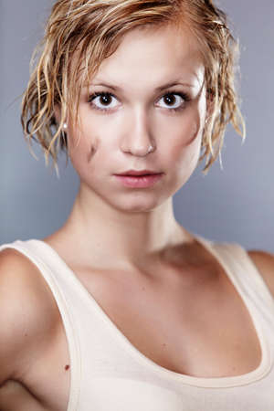 Dirty and wet hair nice blonde girl posing in studio for personal portraits.の写真素材