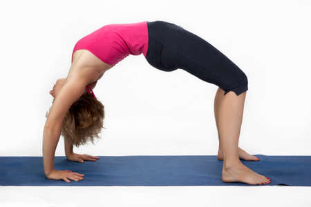 Yoga poses in studio - woman model exercising firs series of yogaの写真素材
