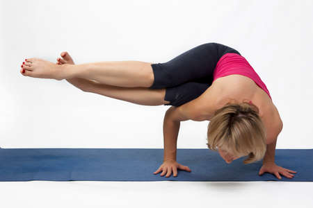 Yoga poses in studio - woman model exercising firs series of yogaの写真素材