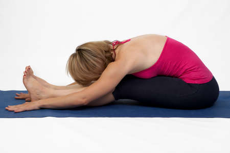 Yoga poses in studio - woman model exercising firs series of yogaの写真素材