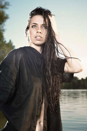 Young female model posing for glamour/fashion photos in summer time by the lake in Middle Bohemia region.の写真素材