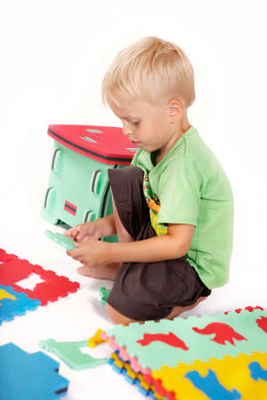 Children at play with color foam toys in studio enjoying their moments of games.の写真素材