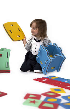 Children at play with set of rubber foam toys in studio on white backgroundの写真素材