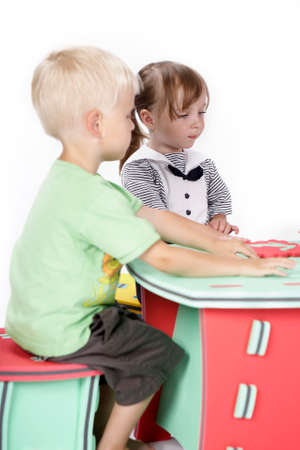 Children at play with color foam toys in studio enjoying their moments of games.の写真素材