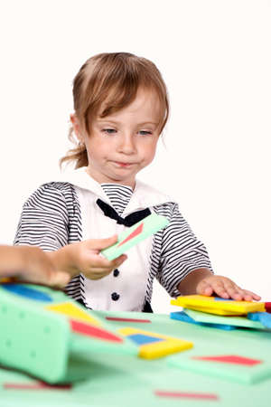 Children at play with color foam toys in studio enjoying their moments of games.の写真素材