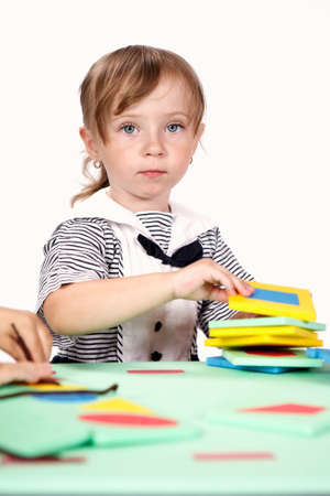 Children at play with color foam toys in studio enjoying their moments of games.の写真素材