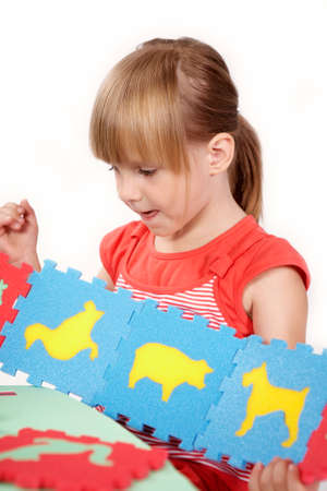 Children at play with color foam toys in studio enjoying their moments of games.の写真素材