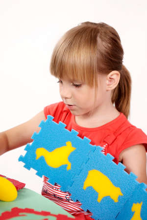 Children at play with color foam toys in studio enjoying their moments of games.の写真素材