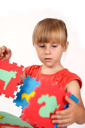 Children at play with color foam toys in studio enjoying their moments of games.の写真素材