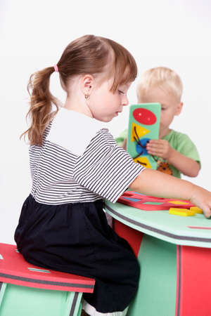 Children at play with color foam toys in studio enjoying their moments of games.の写真素材