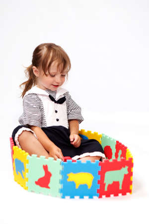 Children at play with color foam toys in studio enjoying their moments of games.の写真素材
