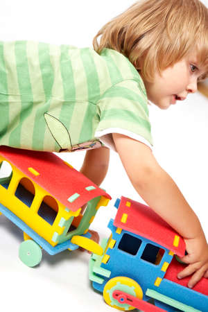 Children at play with color foam toys in studio enjoying their moments of games.の写真素材