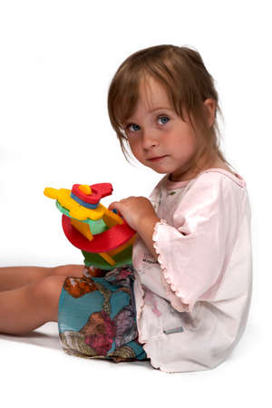 Children at play with set of rubber foam toys in studio on white backgroundの写真素材