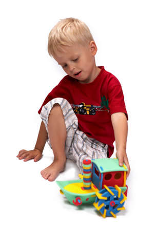 Children at play with set of rubber foam toys in studio on white backgroundの写真素材