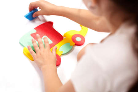 Children at play with color foam toys in studio enjoying their moments of games.の写真素材