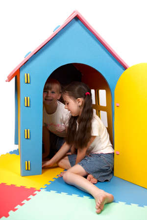 Children at play with set of rubber foam toys in studio on white backgroundの写真素材