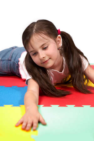 Children at play with set of rubber foam toys in studio on white backgroundの写真素材