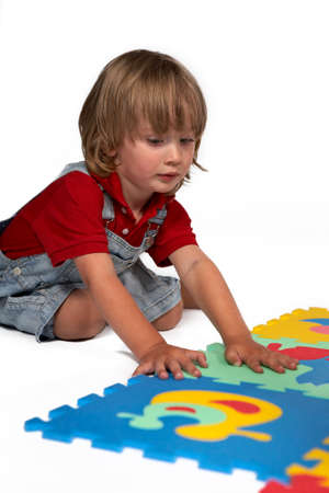 Children at play with set of rubber foam toys in studio on white backgroundの写真素材