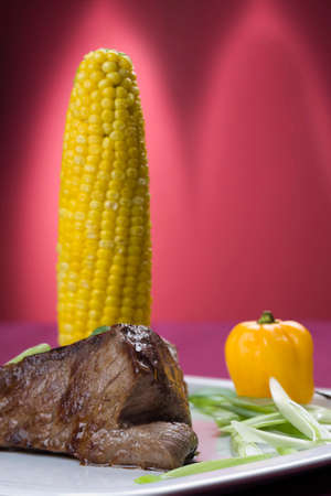 Grilled beef steak with cooked sweet cornの写真素材