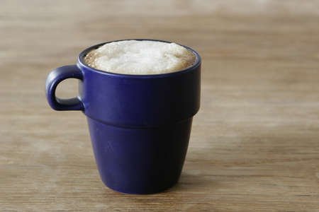 Blue coffee cup on the wooden table