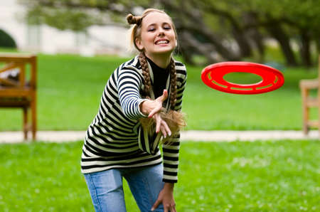 Lady posing in summer city park in striped dressの写真素材
