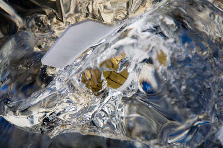 Sim card frosted in ice block in studio