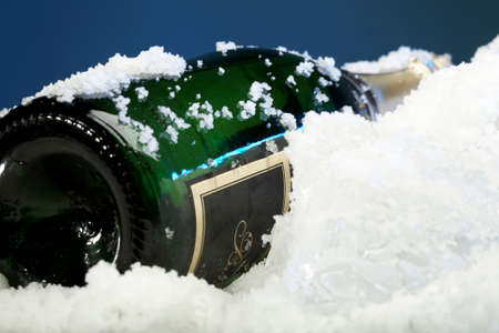 Wine in bottle on snow and ice - serve chilledの写真素材