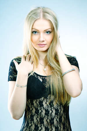 Beautiful blonde lady posing in lingerie for figure and portrait glamour and fashion photos in studio.の写真素材