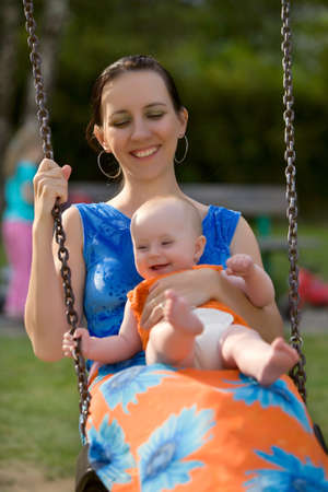 Family relaxing and playing in summer time outdoor in city parkの写真素材