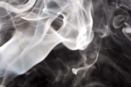 Candle smoke in studio light on black backroundの写真素材