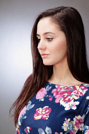 Young lady model posing  in several dress styles for portrait photos in studio.
