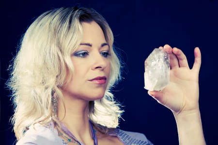 Woman of esoteric soul holding some symbols of taoism and alternative life styles.の写真素材
