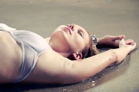 Glamour lady posing on Italian beach near tourist resort Caorle in bikini style outfit.の写真素材