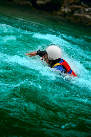 Brave man rides down a wild river kayaking
