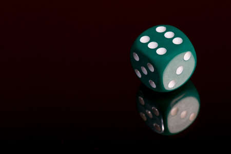Dice on mirror in studio with black designの写真素材