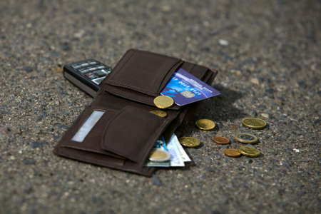 Lost man wallet and mobile at the park sidewalk