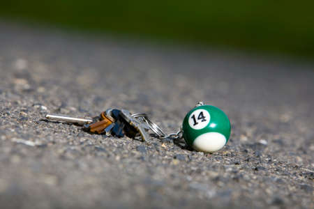 Lost keys with pendant at the park sidewalkの写真素材