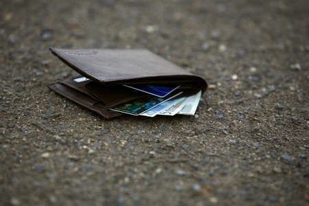 Lost man wallet at the park sidewalk