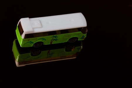 Vehicle model - plastic bus on mirror in studio