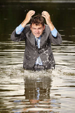 Crazy businessman in suit deep in water