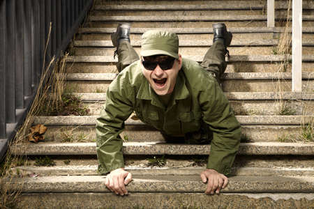 Soldier on sentry duty making fun on stairsの写真素材