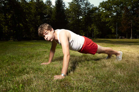Weak man in retro style doing workout in park