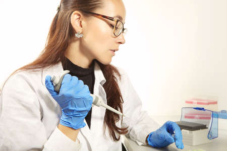 Criminologist lab technician preparing samples for PCR analysis reactionの写真素材