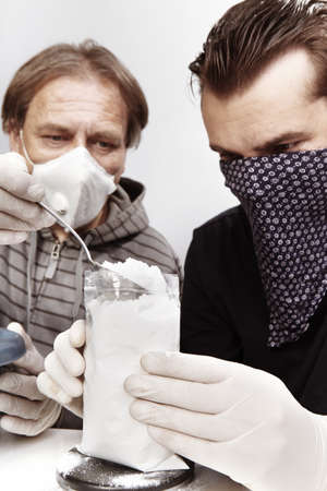 Two dealers packing lot of drugs for distribution