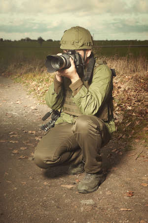 Photographer in war conflict field zone taking picturesの写真素材