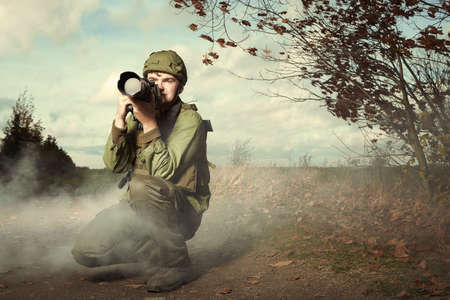 Photographer in war conflict field zone between shootings
