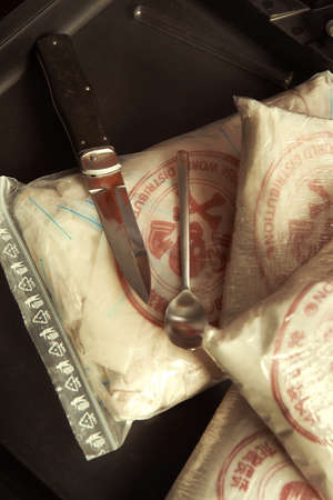 Packages of narcotics in suitcase for testing quality of delivery with chemicals