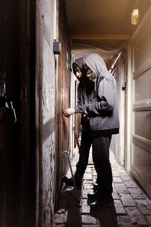 Two teenage burglars breaking in basement cellar with 30 inch bolt cuttersの写真素材